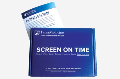The Penn Medicine-branded FIT Kit colorectal screening box; behind it is a brochure titled “Screen on Time” 